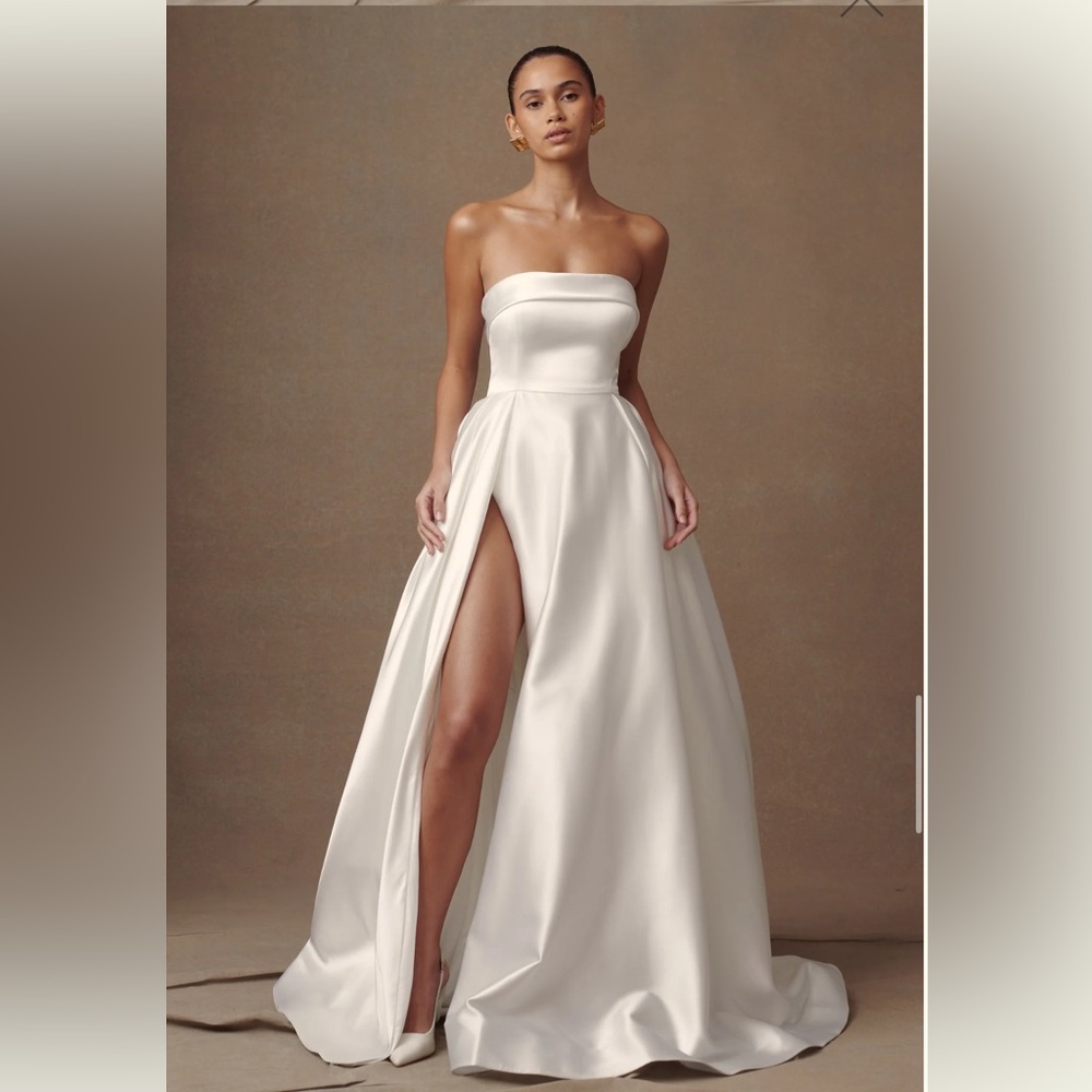 Beautiful like new wedding dress ball gown style w/ high slit.